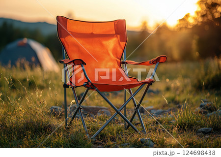Camping chair stands on forest ground with sunlight 124698438