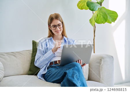 Young woman using laptop for video call, online chat conference sitting at home 124698815