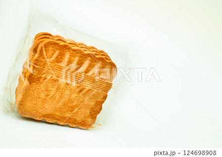 Sweet cookies in a protective cellophane package for sale on a white Sweet cookies in a protective cellophane package for sale on a white 124698908