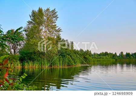 Relaxation on the summer river. A quiet place for fishing Relaxation on the summer river. A quiet place for fishing 124698909