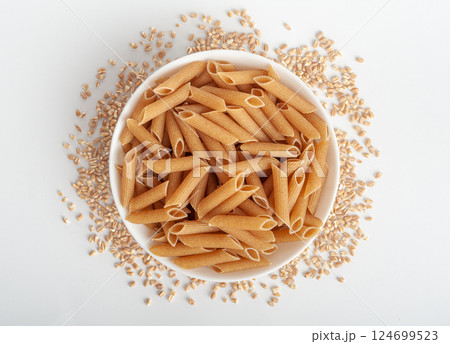Raw Brown Pasta, Wholegrain Penne, Dry Whole Grain Noodle, Raw Spelt Macaroni, Healthy Italy Food Raw Brown Pasta, Wholegrain Penne, Dry Whole Grain Noodle, Raw Spelt Macaroni, Healthy Italy Food 124699523