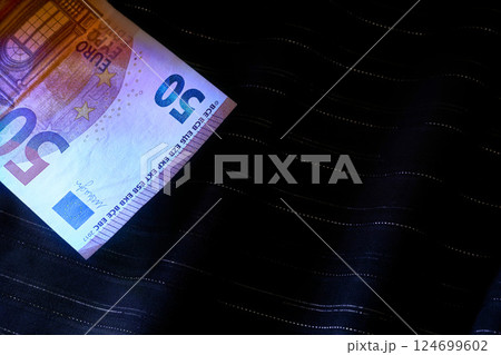 Money.50 euro banknotes on dark blue fabric with lurex Money.50 euro banknotes on dark blue fabric with lurex 124699602