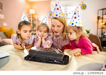 Joyful gathering of friends celebrating a special birthday moment 124699626