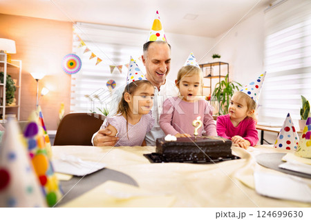 Celebration of joy with children and a birthday cake in a vibrant room Celebration of joy with children and a birthday cake in a vibrant room 124699630