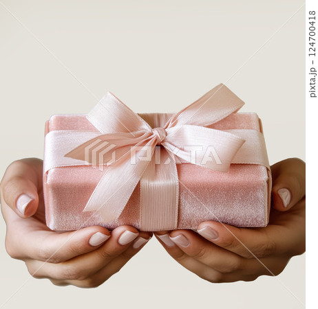 Woman hands holding pink gift satin ribbon, shopping Valentines, New Year, Mothers, Christmas 124700418