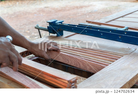 Carpenter working with equipment on wooden table, working with wooden door in new home interior industry. Carpenter working with equipment on wooden table, working with wooden door in new home interior industry. 124702634