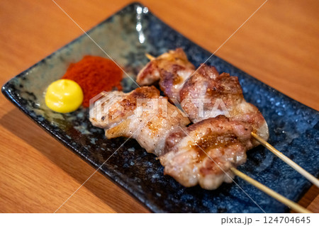 Yakitori, a Japanese type of skewered chicken served on plate 124704645