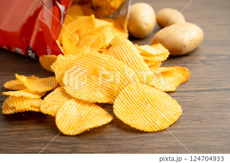 Potato chips , delicious BBQ seasoning spicy for crips, thin slice deep fried snack fast food. 124704933