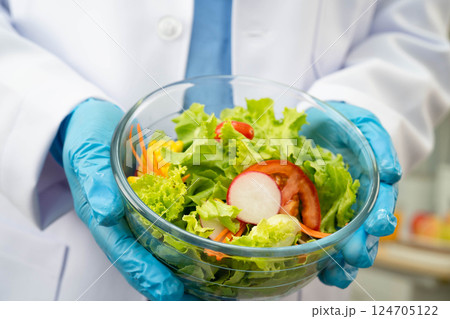 Asian Nutritionist holding healthy food for patient in hospital, nutrition and vitamin. Asian Nutritionist holding healthy food for patient in hospital, nutrition and vitamin. 124705122