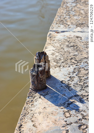 Cracked Reinforced concrete bridge railing visible internal reinforcement, Broken or weak concrete. 124706229