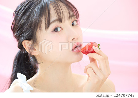 ピンク背景で撮影をした若い女性の爽やかな美容イメージ 124707748