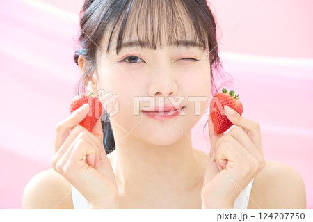ピンク背景で撮影をした若い女性の爽やかな美容イメージ 124707750