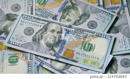 Various Currency Bills are Stacked Together, Highlighting the Prominence of Hundred Dollar Notes 124708693