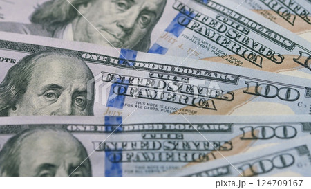 A closeup view of American Hundred Dollar Bills showing their intricate design features A closeup view of American Hundred Dollar Bills showing their intricate design features 124709167