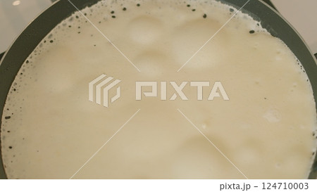 Simmering Creamy Liquid in a Pan on the Stove, Perfect for Many Different Dishes Simmering Creamy Liquid in a Pan on the Stove, Perfect for Many Different Dishes 124710003