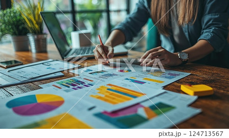 Business analytics and strategy development with colorful data charts and laptop in office setting 124713567