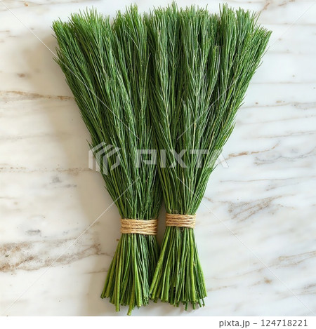 Natural home decor: rustic green pine needles bundles on marble background for eco-friendly design 124718221