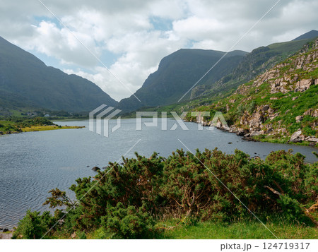 Stunning view of Black Lake surrounded by mountains and greenery in Ireland on a cloudy day. 124719317