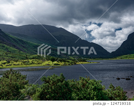 Nestled between rolling hills and valleys, Black Lake offers a tranquil setting in Ireland, with cloudy skies, water's surface, creating a serene landscape. 124719318