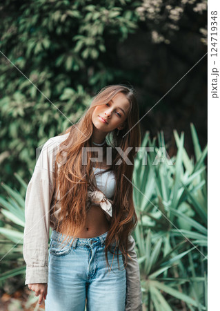 Beautiful adorable girl outdoors in the park enjoying summer day 124719348
