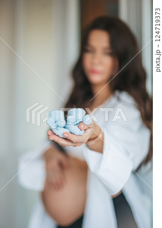 Beautiful pregnant woman at home in the doorway Beautiful pregnant woman at home in the doorway 124719373