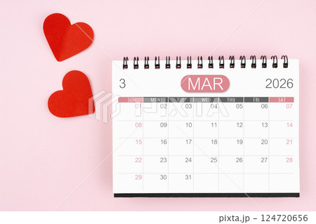 Red heart with March 2026 desk calendar on pink background. Red heart with March 2026 desk calendar on pink background. 124720656