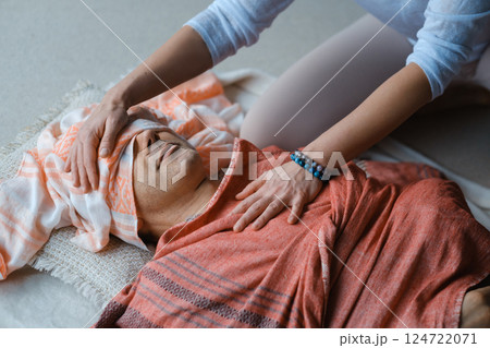 Relaxation and healing through gentle massage in a serene indoor setting during a wellness session Relaxation and healing through gentle massage in a serene indoor setting during a wellness session 124722071