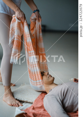 Healing session in a serene studio with a therapist assisting a patient in a laid-back atmosphere on a tranquil morning Healing session in a serene studio with a therapist assisting a patient in a laid-back atmosphere on a tranquil morning 124722079