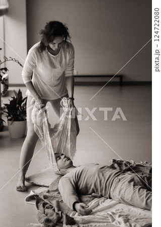 Healing session in a serene studio with a therapist assisting a patient in a laid-back atmosphere on a tranquil morning 124722080