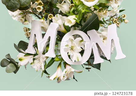 Happy mother's day. A beautiful floral arrangement with the word MOM 124723178