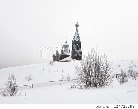 The dome of a wooden chapel in the snow. The dome of a wooden chapel in the snow. 124723298
