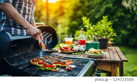 Man grilling sandwiches on barbecue grill for garden party 124723509