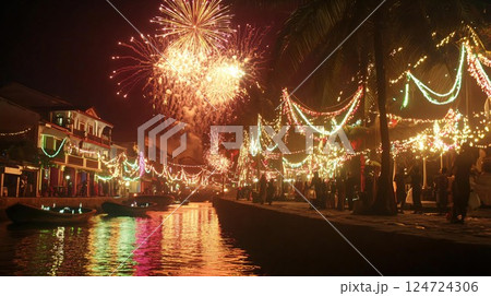Crowd walking along decorated canal during fireworks display 124724306