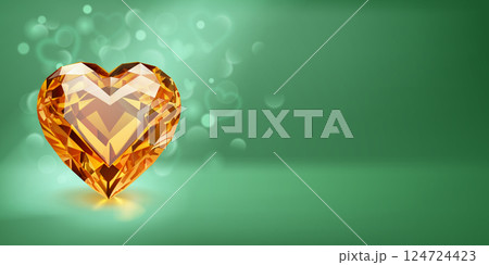 Sparkling yellow heart-shaped gemstone on green. 124724423