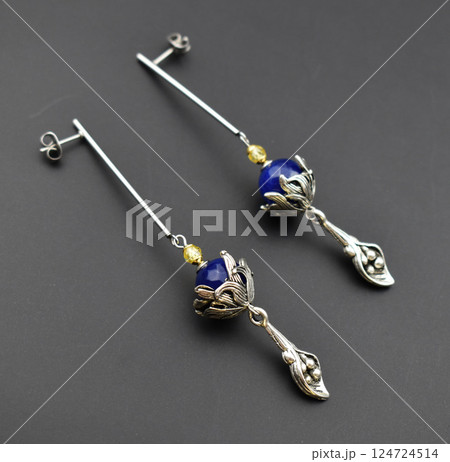 Unique earrings for women on a black background, promotional photo for an online vintage and handmade jewelry store 124724514