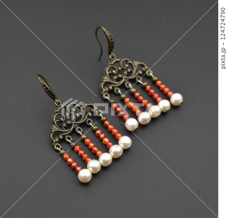 Unique earrings for women on a black background, promotional photo for an online vintage and handmade jewelry store 124724790