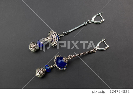 Unique earrings for women on a black background, promotional photo for an online vintage and handmade jewelry store 124724822