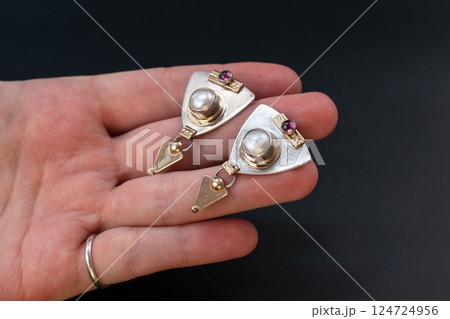 Unique earrings for women on a black background, promotional photo for an online vintage and handmade jewelry store Unique earrings for women on a black background, promotional photo for an online vintage and handmade jewelry store 124724956