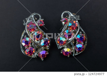 Unique earrings for women on a dark background, promotional photo for an online vintage and handmade jewelry store Unique earrings for women on a dark background, promotional photo for an online vintage and handmade jewelry store 124724977