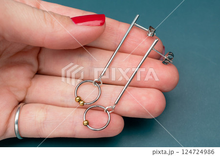 Unique earrings for women on a dark background, promotional photo for an online vintage and handmade jewelry store 124724986