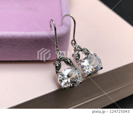 Unique earrings for women on a pink background, promotional photo for an online vintage and handmade jewelry store Unique earrings for women on a pink background, promotional photo for an online vintage and handmade jewelry store 124725043