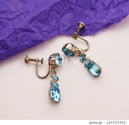 Unique earrings for women on a purple background, promotional photo for an online vintage and handmade jewelry store Unique earrings for women on a purple background, promotional photo for an online vintage and handmade jewelry store 124725352