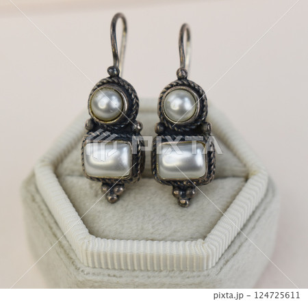 Unique earrings for women on a white background, promotional photo for an online vintage and handmade jewelry store 124725611