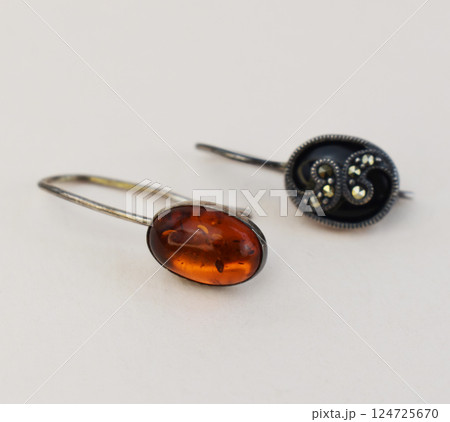 Unique earrings for women on a white background, promotional photo for an online vintage and handmade jewelry store Unique earrings for women on a white background, promotional photo for an online vintage and handmade jewelry store 124725670