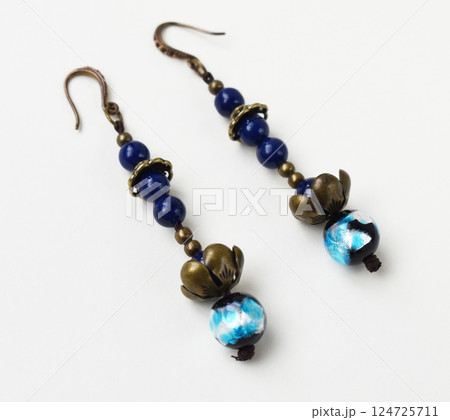 Unique earrings for women on a white background, promotional photo for an online vintage and handmade jewelry store Unique earrings for women on a white background, promotional photo for an online vintage and handmade jewelry store 124725711