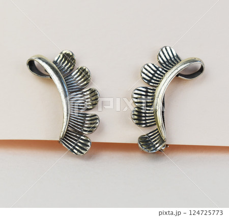 Unique earrings for women on a white background, promotional photo for an online vintage and handmade jewelry store Unique earrings for women on a white background, promotional photo for an online vintage and handmade jewelry store 124725773