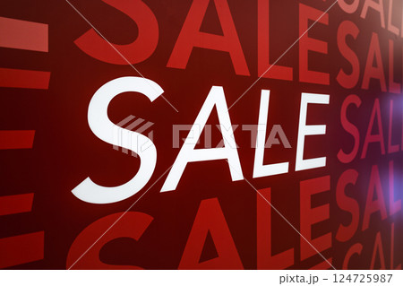 Bold red sale sign displayed prominently on retail store window Bold red sale sign displayed prominently on retail store window 124725987