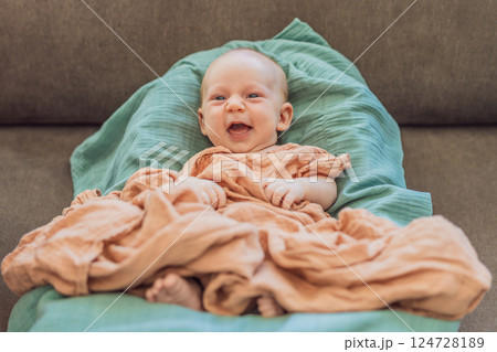 Newborn baby comfortably resting in a cozy baby nest. Safe and peaceful sleep concept for infants 124728189