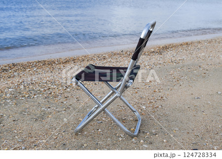 Folding chair by the sea. Convenience to the tourist. Rest by the sea. Folding chair by the sea. Convenience to the tourist. Rest by the sea. 124728334