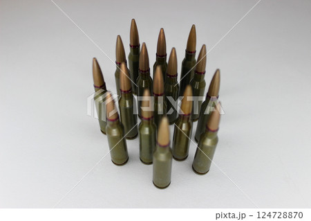 Group Of Ammunition Cartridges With Selective Focus Isolated On White Symbolizing A Squad Of Soldiers Group Of Ammunition Cartridges With Selective Focus Isolated On White Symbolizing A Squad Of Soldiers 124728870